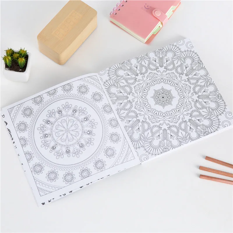 A5 mandala colouring book open showing black ink patterns on white paper with soft binder cover