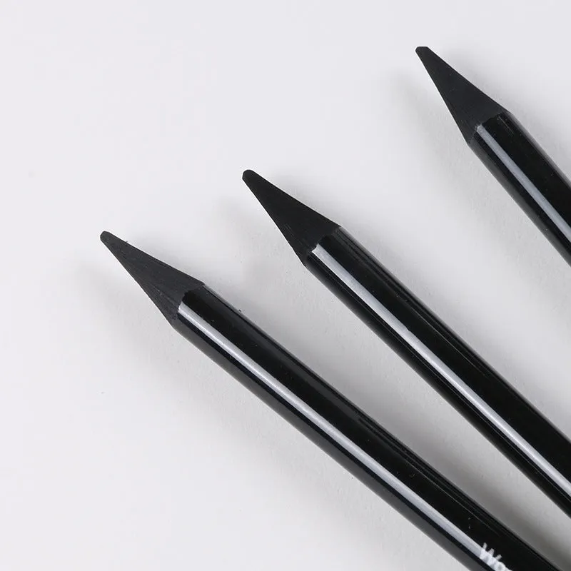 Set of nine graphite and carbonised drawing pencils in wooden casings on a suction card.