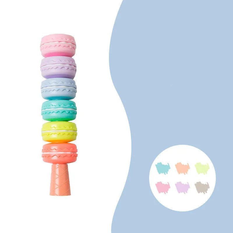 Set of six colourful cookie-shaped highlighter pens with macaron colours arranged on a white surface.