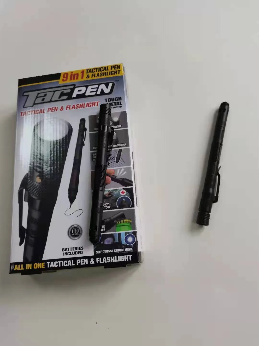 Nine-in-one multi-function flashlight survival pen in black with dual light sources and car window breaker