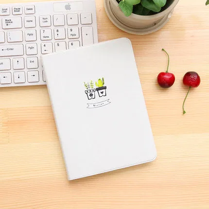 Leather handbook notebook 36K with 112 beige pages closed, showing blue red and white colour options
