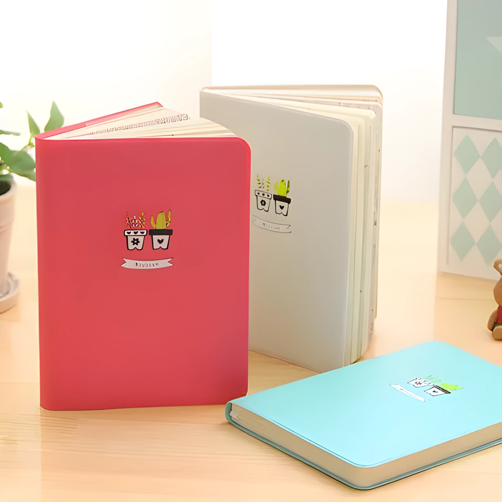 Leather handbook notebook 36K with 112 beige pages closed, showing blue red and white colour options