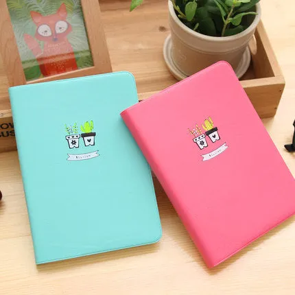 Leather handbook notebook 36K with 112 beige pages closed, showing blue red and white colour options