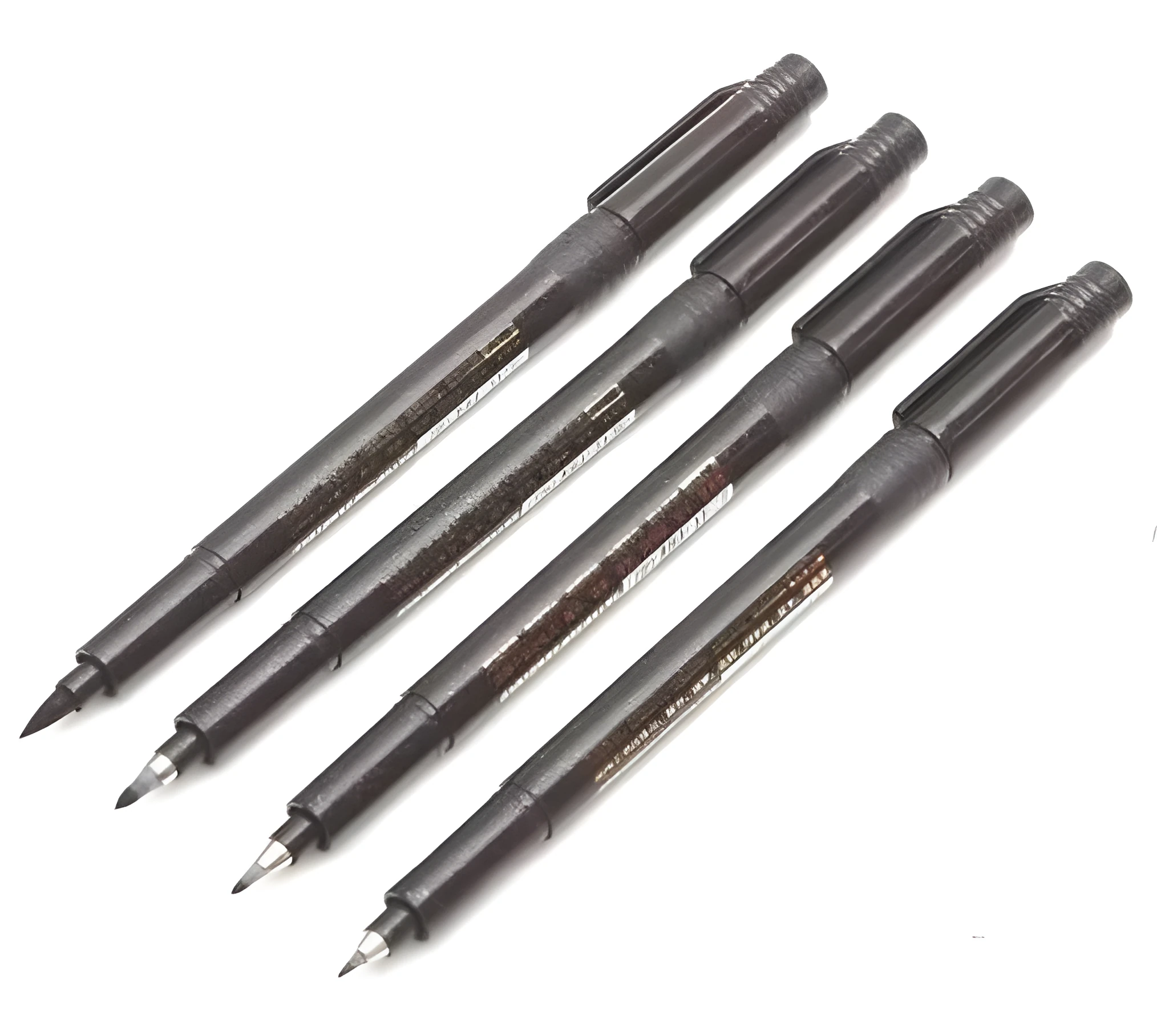 Set of four Japanese calligraphy brush pens and refills for ink drawing and sumi-e painting.