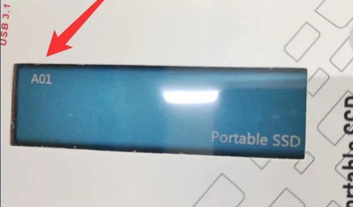Ultra-thin external mobile solid-state drive with a metal shell, showing red interface connector.