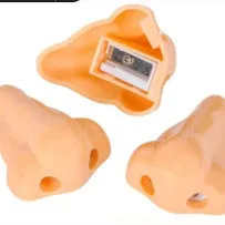 Flesh colour plastic manual pencil sharpener with big nostril hole on geometric body.