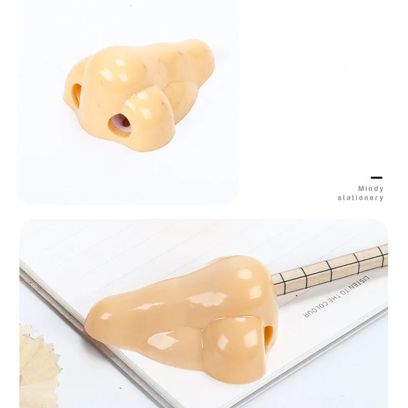 Flesh colour plastic manual pencil sharpener with big nostril hole on geometric body.