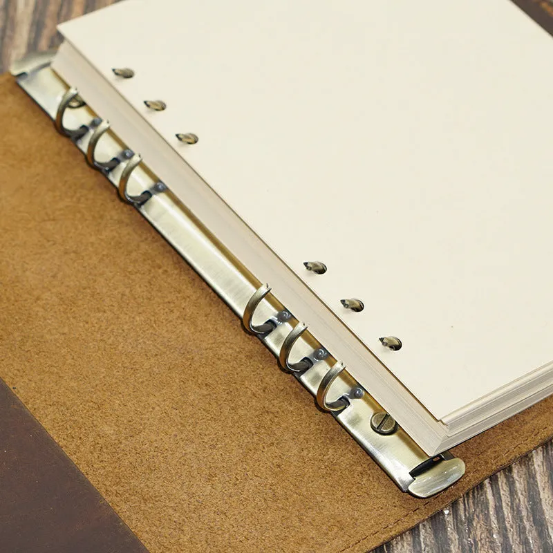 A5 handmade cowhide notebook with genuine leather cover in Crazy Horse Brown, opened on a table