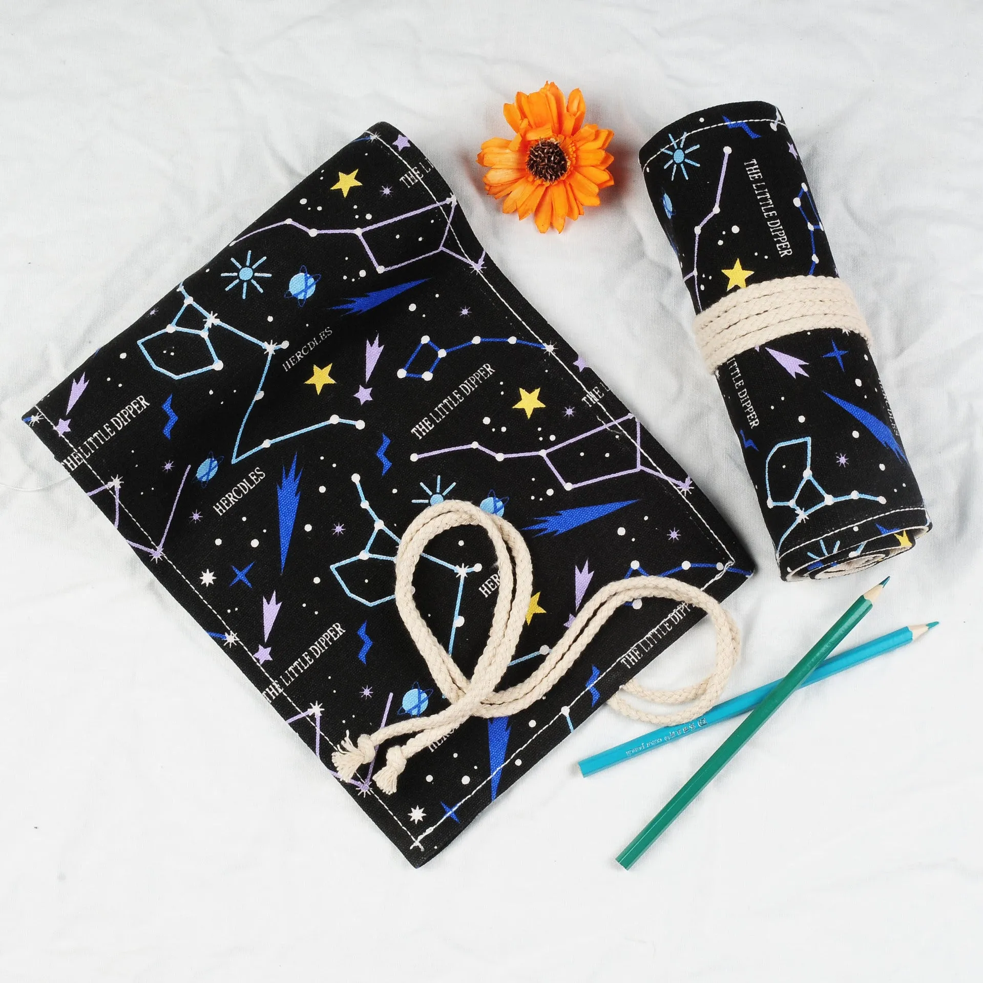 Canvas pencil case roll with starry sky pattern showing organised colour pencil slots