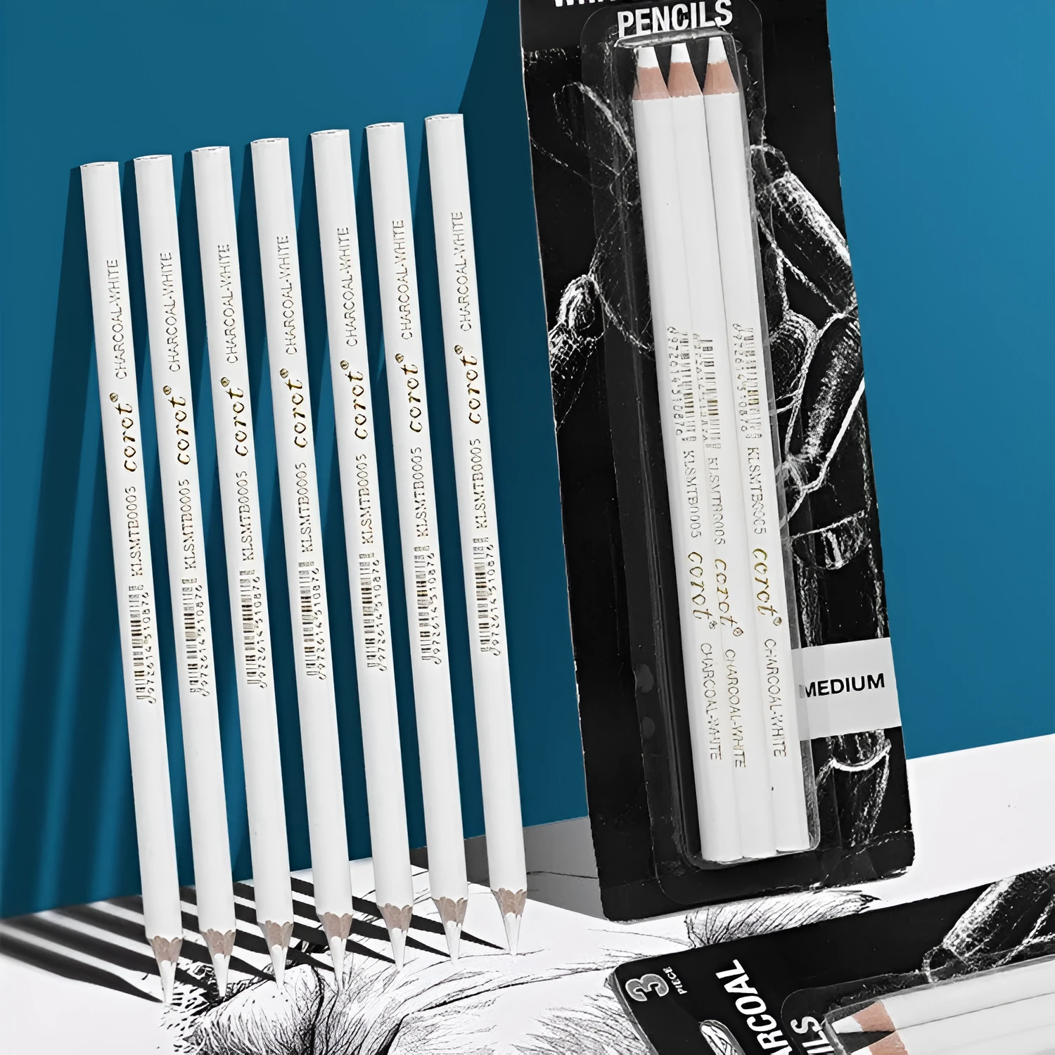 Set of three white charcoal pencils in wooden barrels for sketching on dark paper