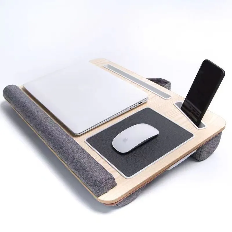 Foldable laptop desk in black walnut colour on a bed with laptop open