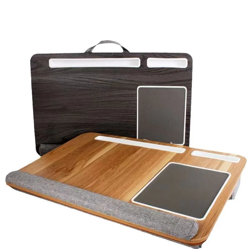 Foldable laptop desk in black walnut colour on a bed with laptop open