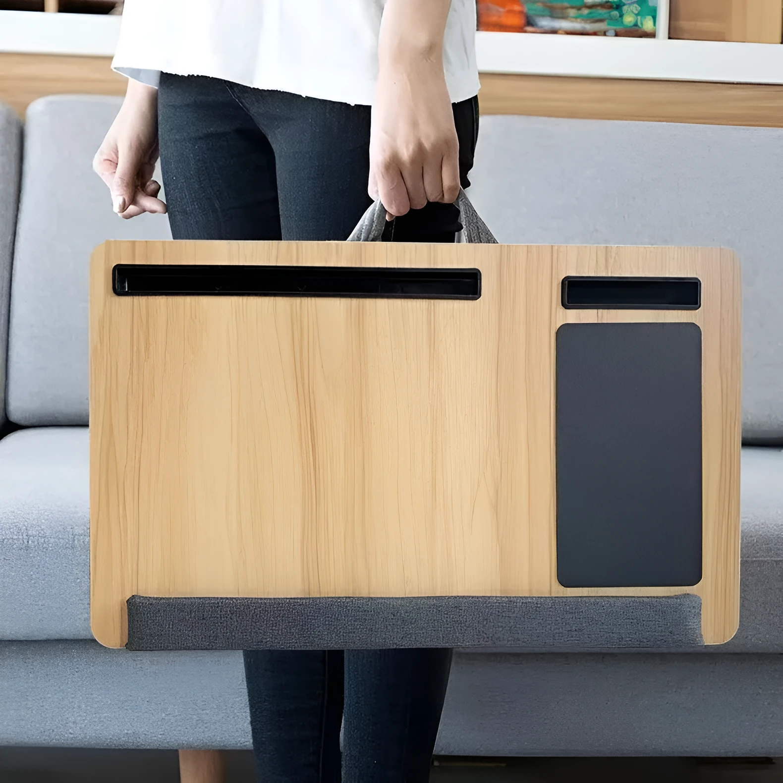 Foldable laptop desk in black walnut colour on a bed with laptop open