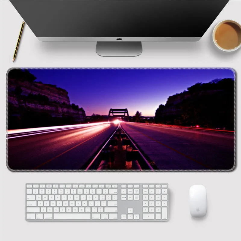 Landscape mouse mat with rubber base and cloth surface on a desk, showing heat transfer printed image