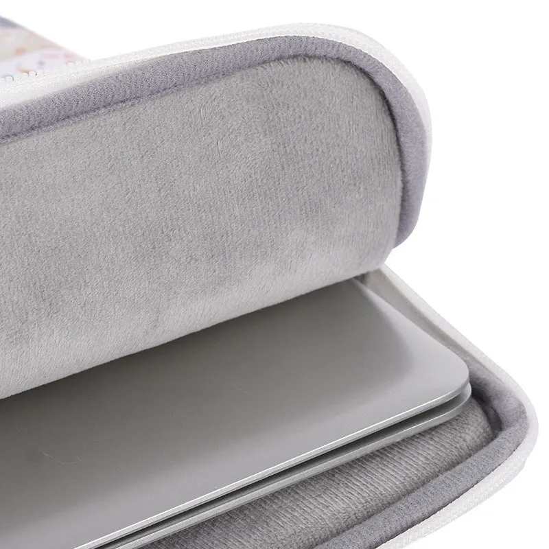 White waterproof PU leather laptop inner sleeve for a 14-inch computer on a table.