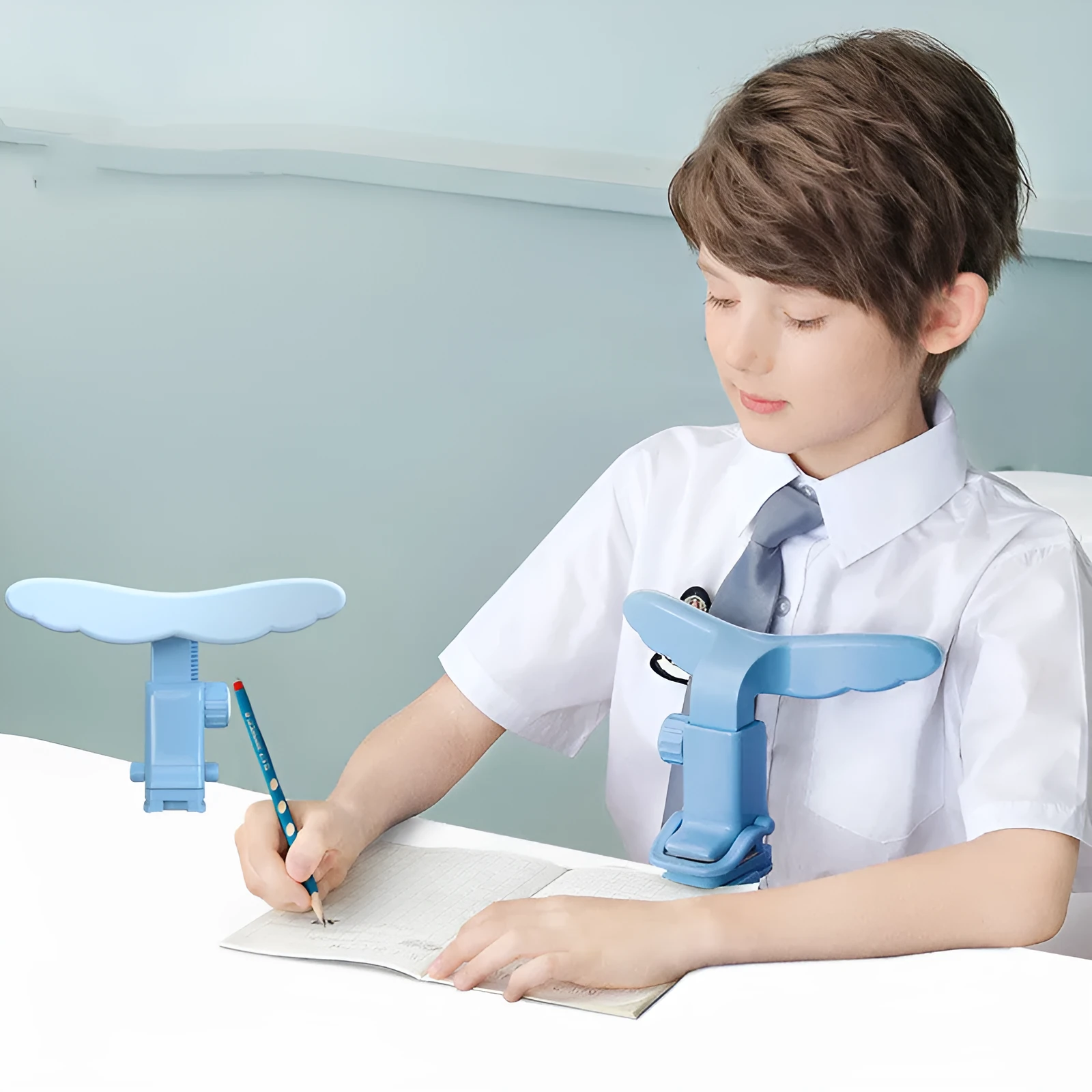 Student anti-myopia seated orthotics posture corrector with silicone chin support on a desk, blue frame