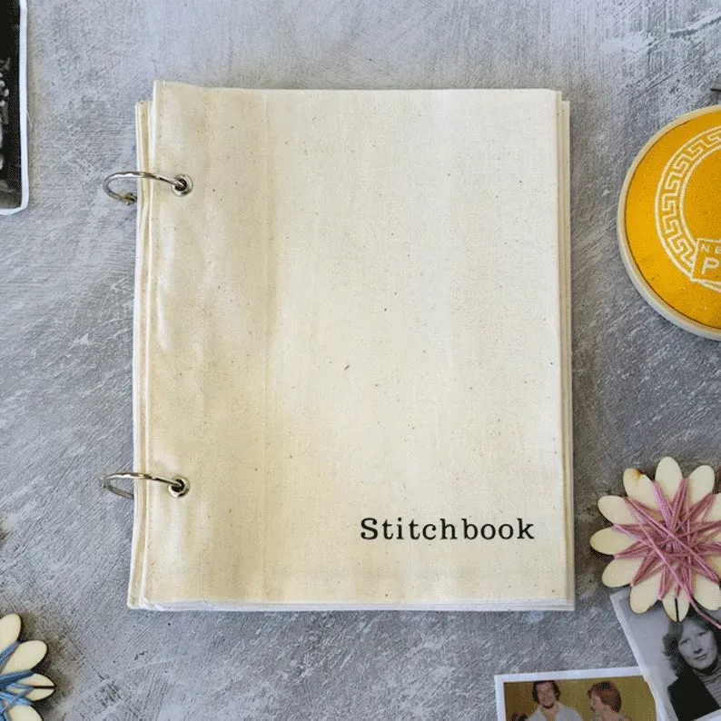 Linen stitch fabric sketchbook in beige square format with ring binding and waist seal