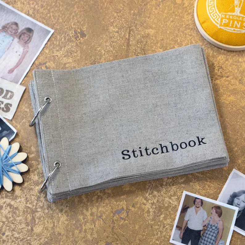 Linen stitch fabric sketchbook in beige square format with ring binding and waist seal