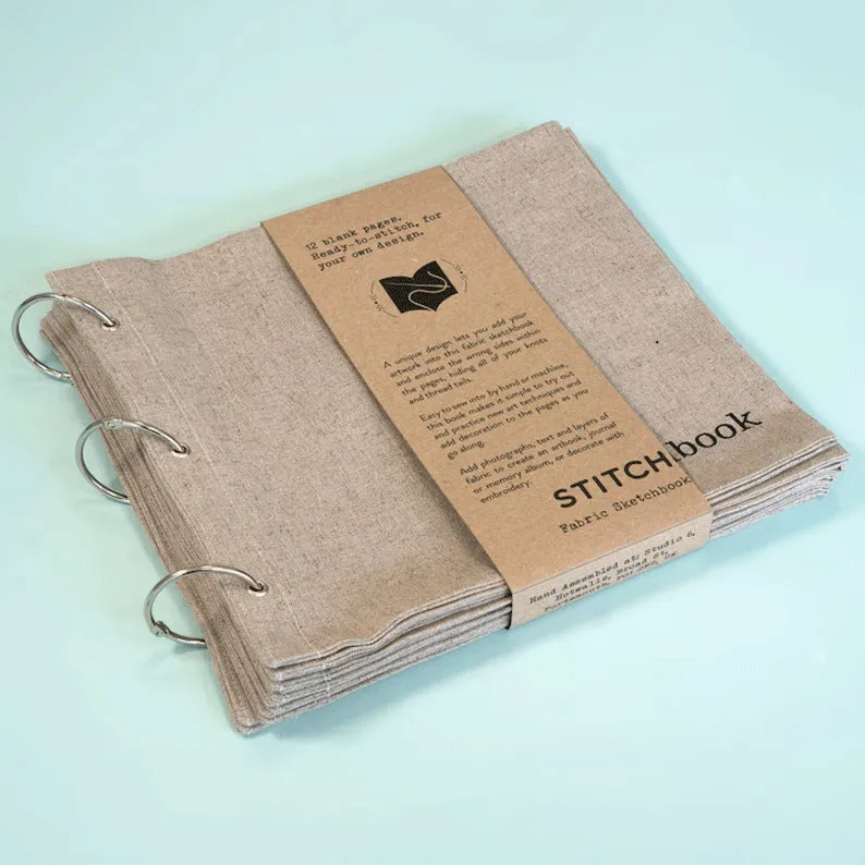 Linen stitch fabric sketchbook in beige square format with ring binding and waist seal