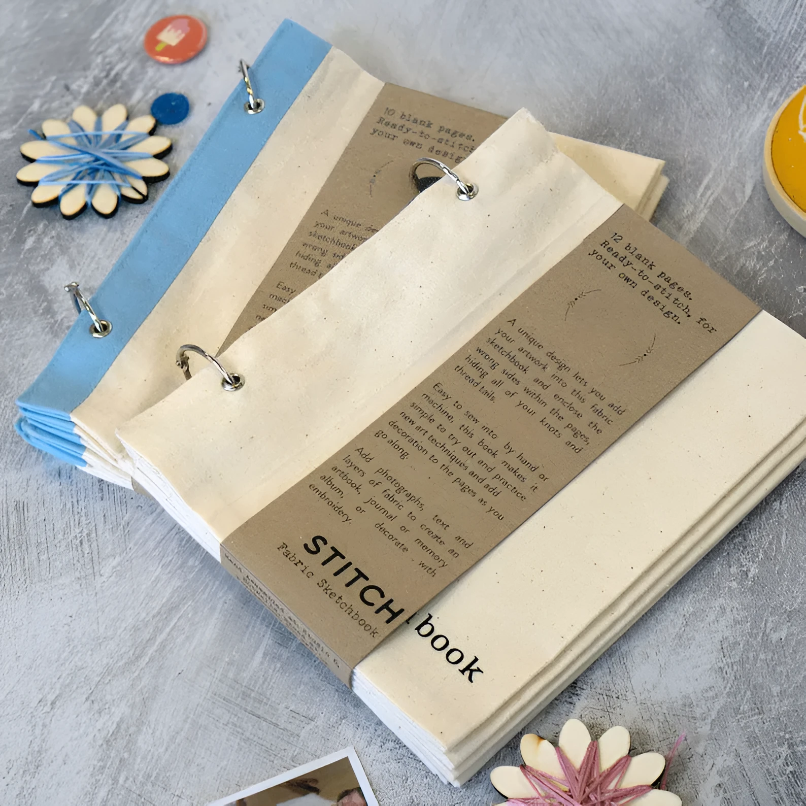 Linen stitch fabric sketchbook in beige square format with ring binding and waist seal