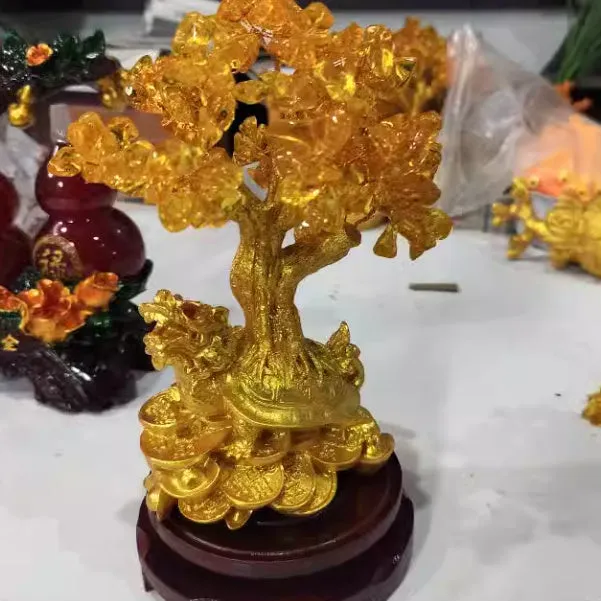Citrine coloured resin money tree ornament with small water turtle model in Chinese style.