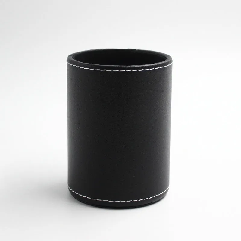 Black leather cylindrical pen holder measuring 8cm wide × 10.8cm tall on desk