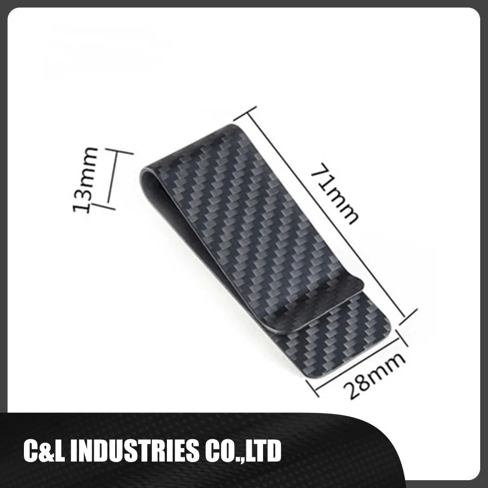 Glossy black genuine carbon fiber money clip on a flat surface, showing striped pattern and slim profile