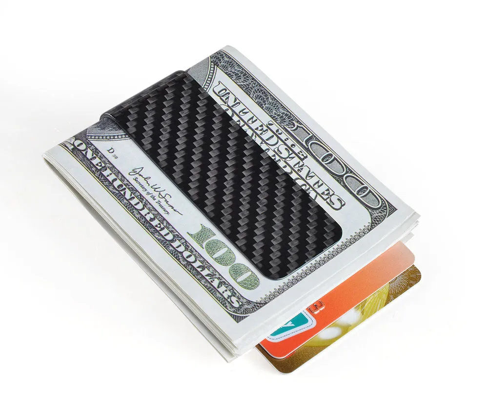 Glossy black genuine carbon fiber money clip on a flat surface, showing striped pattern and slim profile