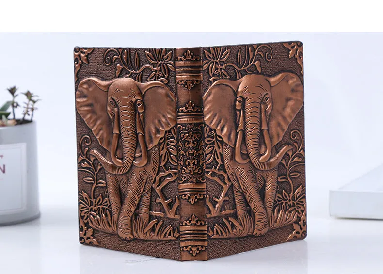 Hardcover PU leather notebook with embossed retro cover and brushed bronze details, open at 180 degrees showing beige pages