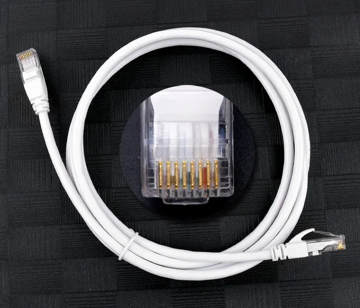 White Cat6 network cable with RJ-45 connectors on a plain background