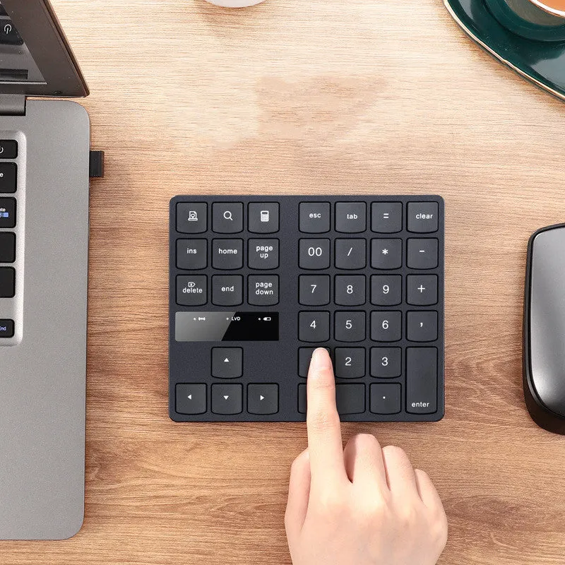 Black wireless numeric keyboard with 35 keys, ABS construction, 145x120x19mm dimensions, USB charging cable and receiver visible