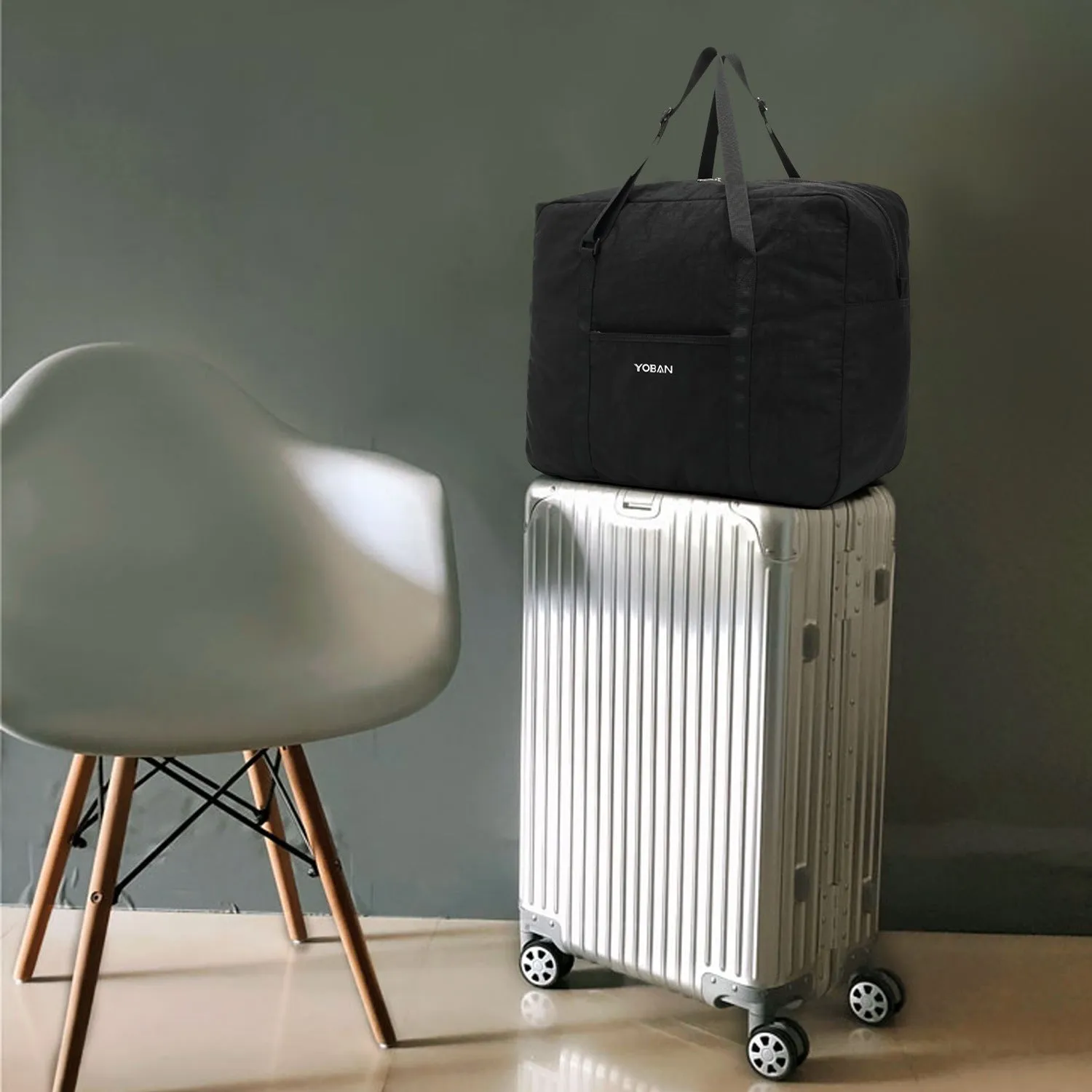 Large waterproof foldable travel bag in black with 20-35L capacity and zipper closure