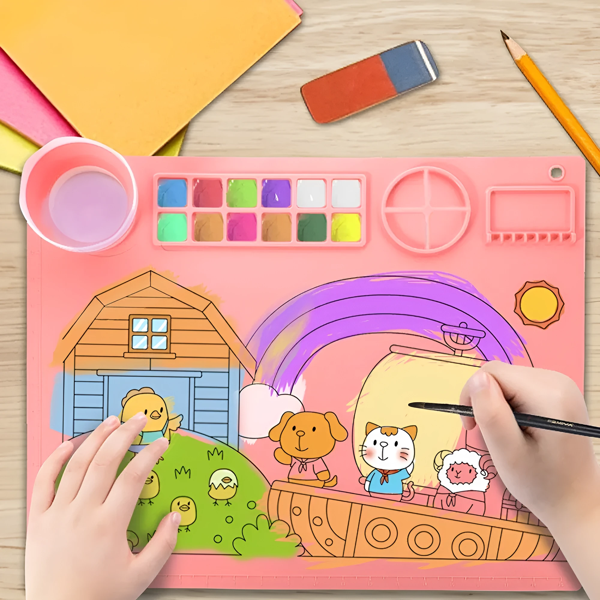 Light blue silicone painting mat measuring 50 by 40 centimetres on a wooden table.
