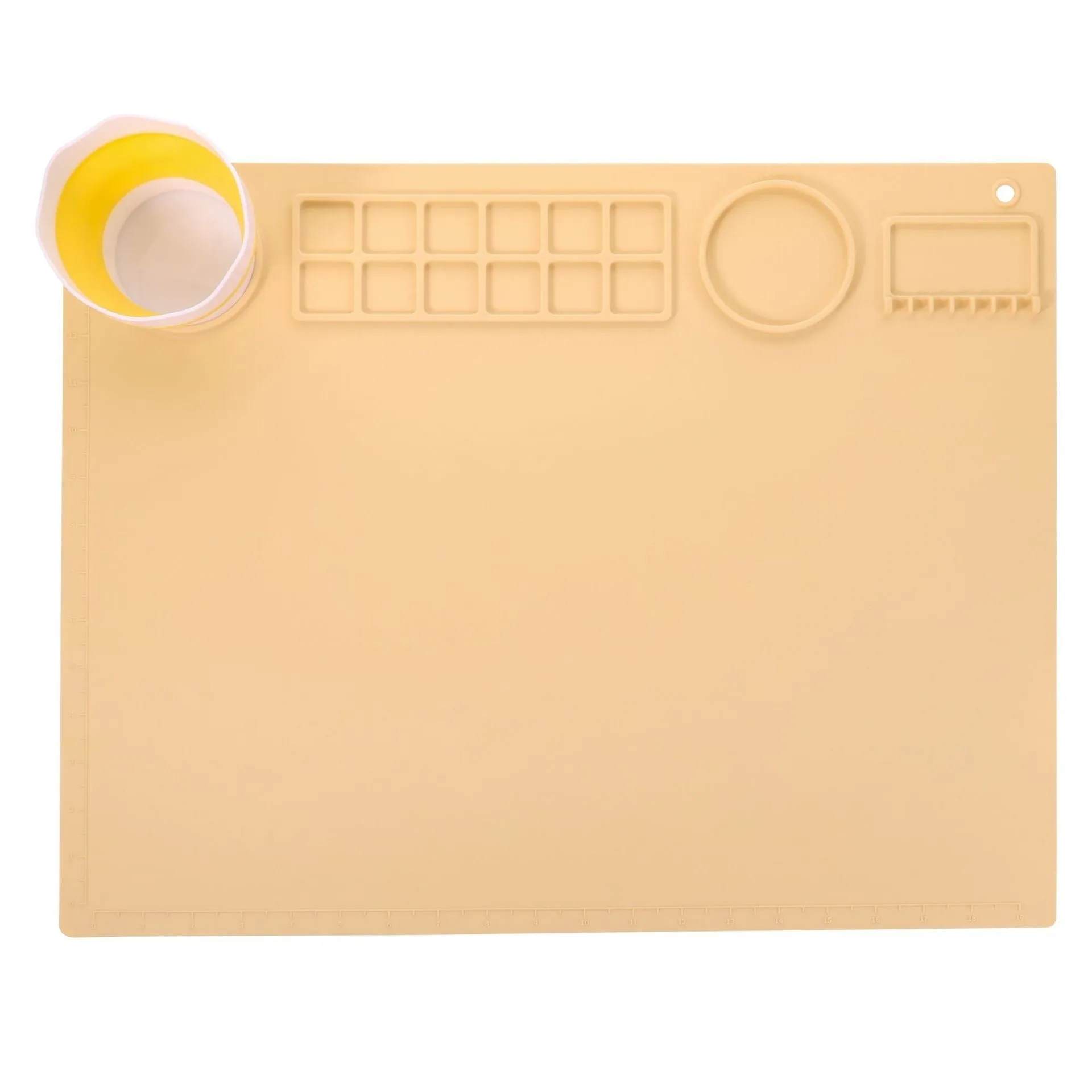 Light blue silicone painting mat measuring 50 by 40 centimetres on a wooden table.