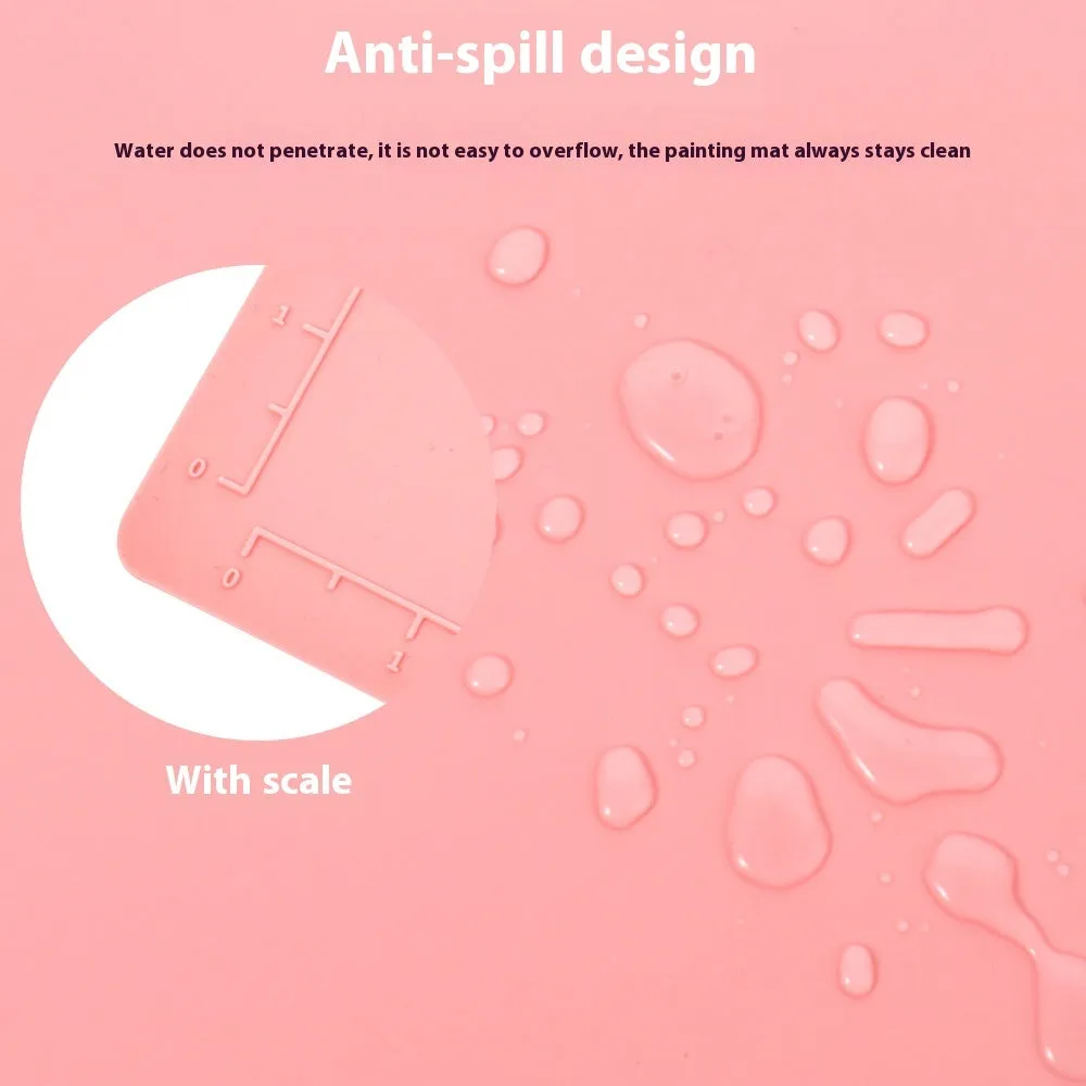 Light blue silicone painting mat measuring 50 by 40 centimetres on a wooden table.
