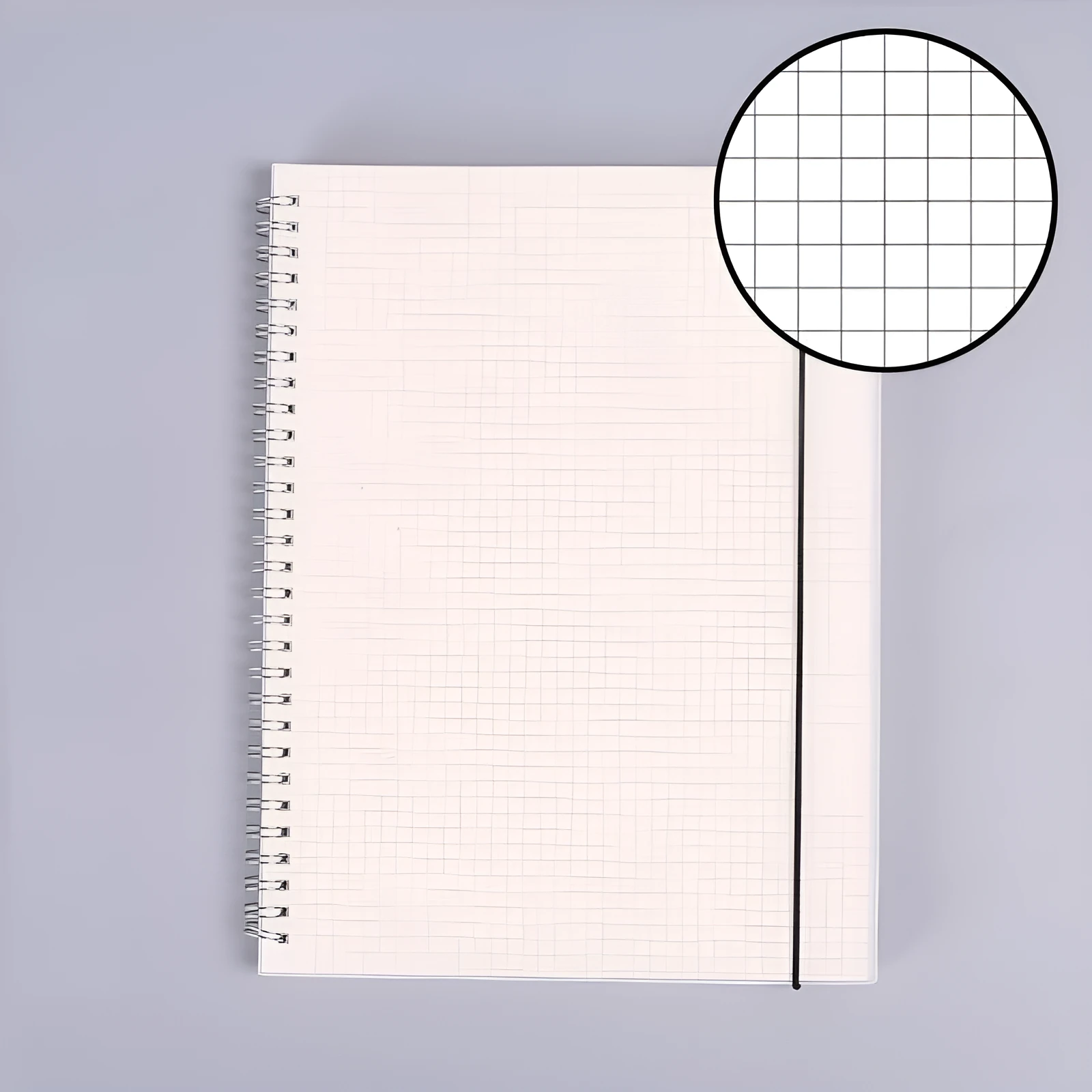 B5 coil grid notebook with Pp cover, open showing lined pages on a desk