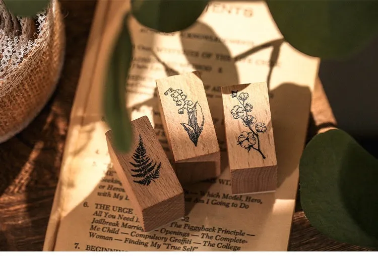 Mr Paper Seal Suit wooden stamp set showing seven stamps in either stars and moon or botanical designs on a craft table.