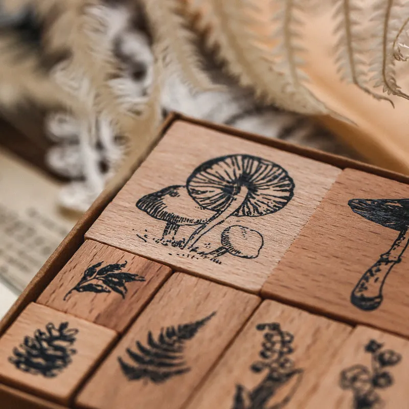 Mr Paper Seal Suit wooden stamp set showing seven stamps in either stars and moon or botanical designs on a craft table.