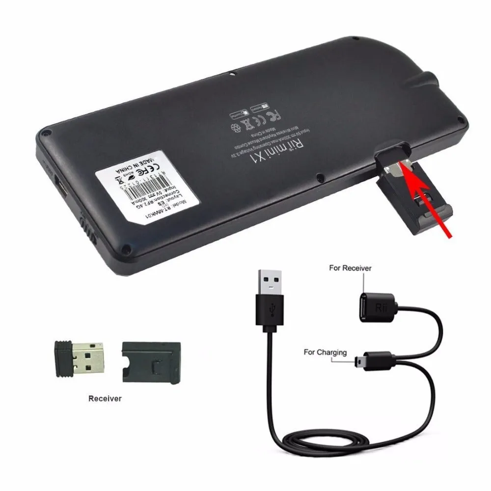 Black wireless mini keyboard with built-in trackpad and 2.4GHz receiver on a desk