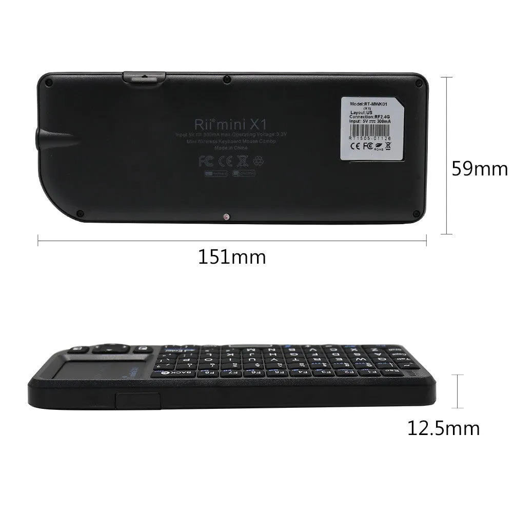 Black wireless mini keyboard with built-in trackpad and 2.4GHz receiver on a desk
