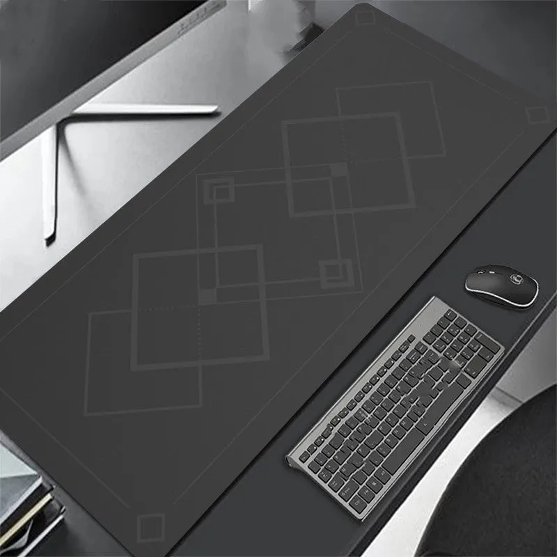 All black extra long mouse pad with precision overlock stitching on a desk