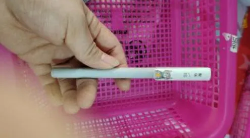 Black gel pen with full needle tube tip and plastic body on white background