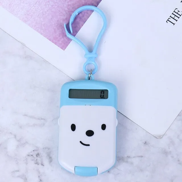 Creative cookie-shaped cute mini calculator in pink with key ring on a white background