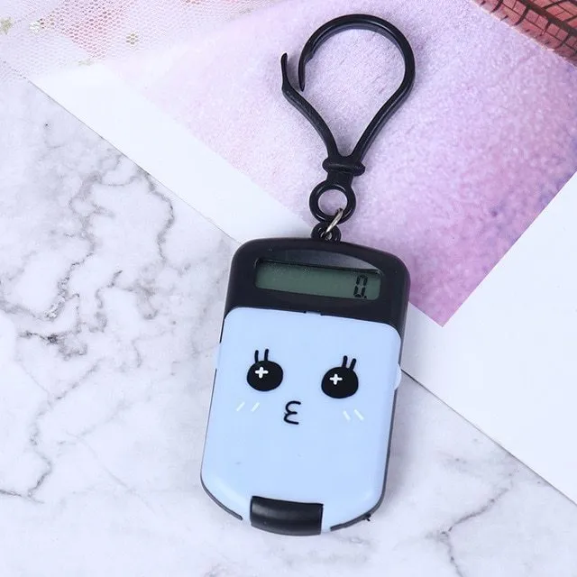 Creative cookie-shaped cute mini calculator in pink with key ring on a white background