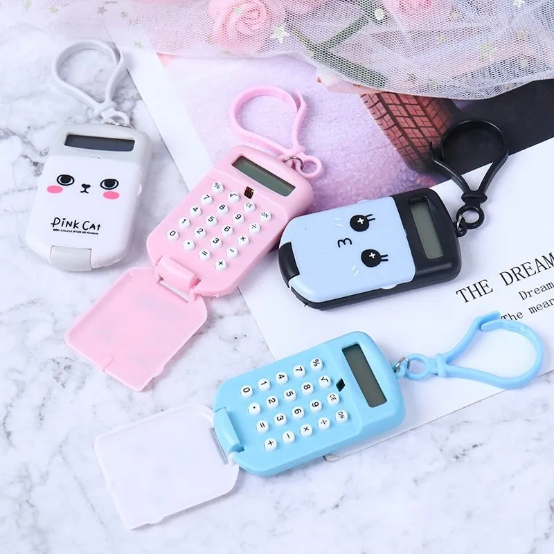 Creative cookie-shaped cute mini calculator in pink with key ring on a white background