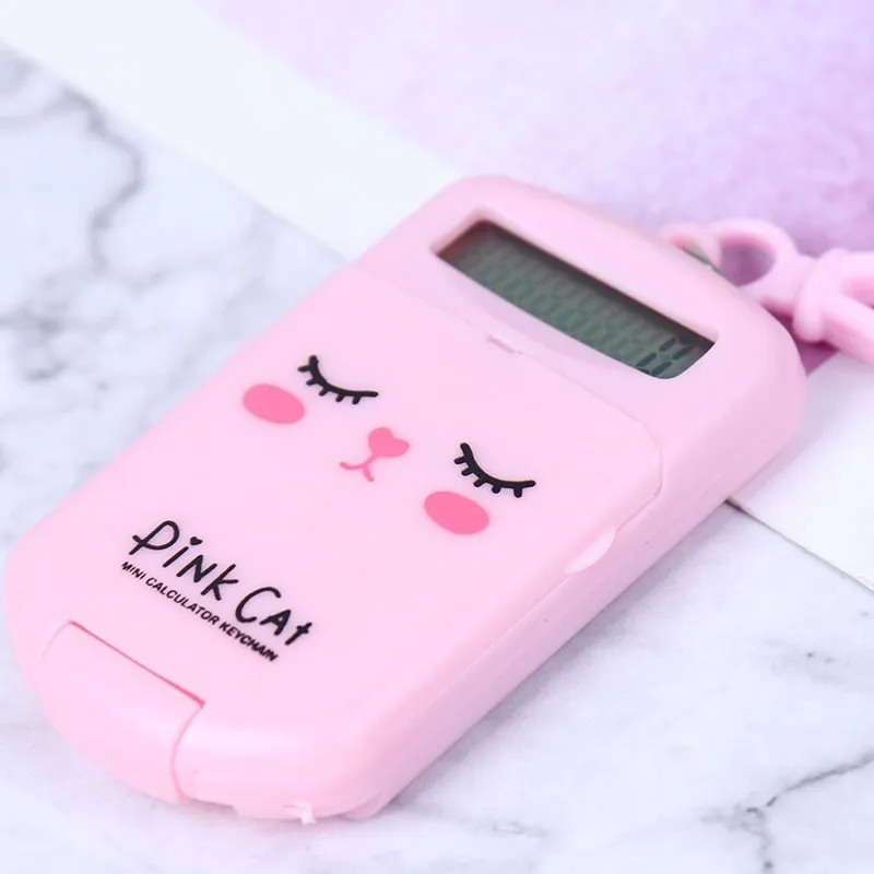 Creative cookie-shaped cute mini calculator in pink with key ring on a white background
