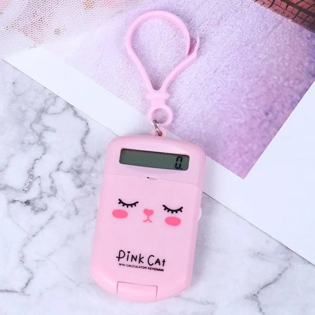 Creative cookie-shaped cute mini calculator in pink with key ring on a white background