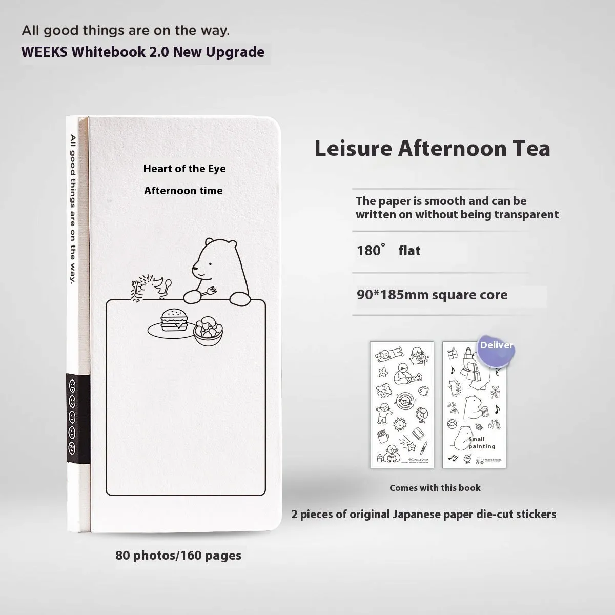 Small white paper notebook with plaid pages, mesh cover, and a pair of decorative stickers.