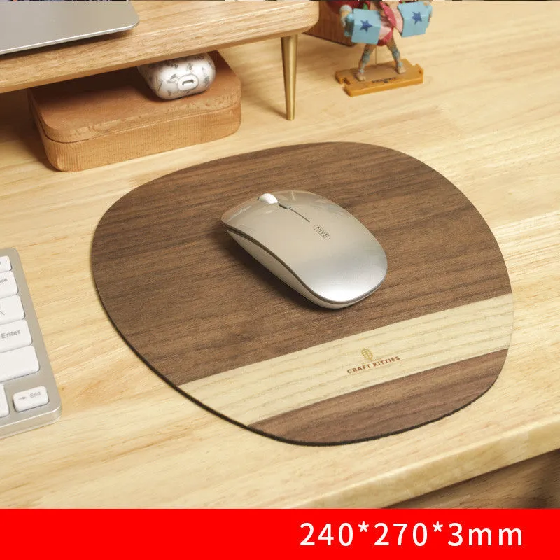 Extra large mouse pad with walnut wood surface and natural rubber base on a desk