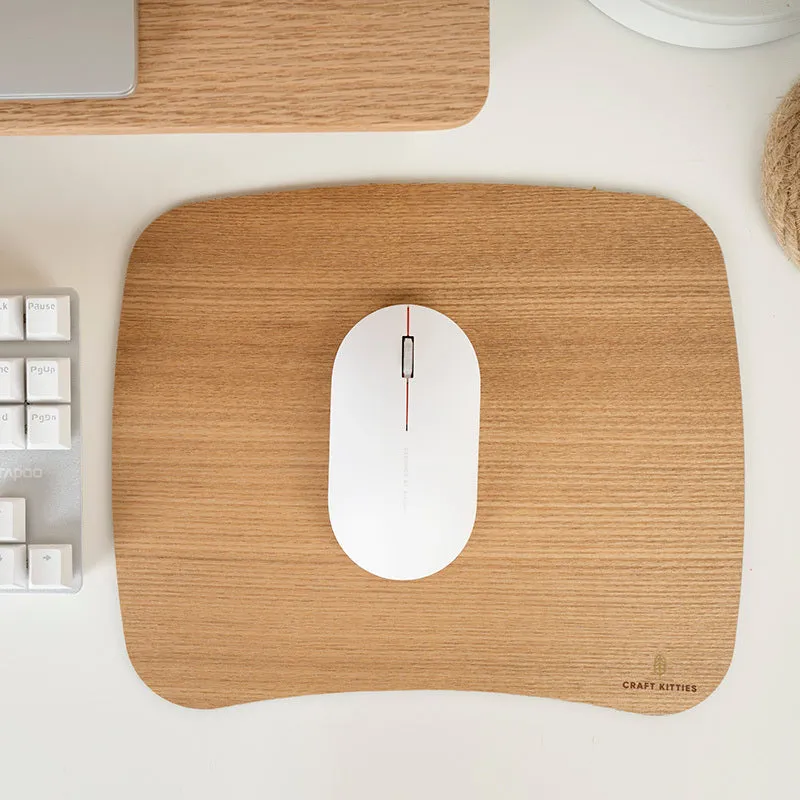Extra large mouse pad with walnut wood surface and natural rubber base on a desk